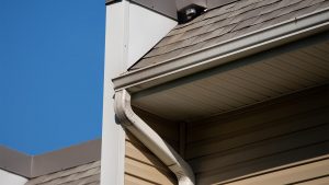 New rain gutter on a home against blue sky 