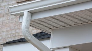 Gutters with a gutter protection system installed on top
